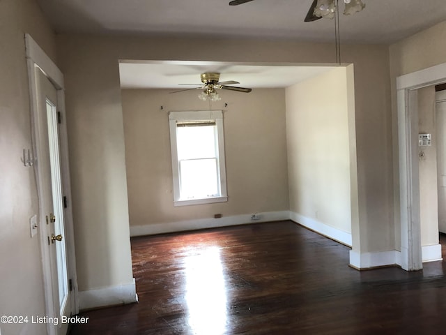 spare room featuring dark hardwood / wood-style flooring and ceiling fan