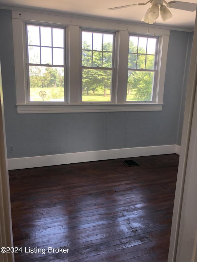 unfurnished room with ceiling fan, plenty of natural light, and dark hardwood / wood-style flooring