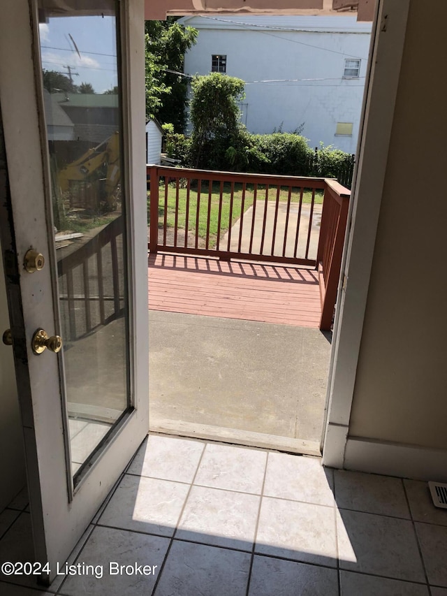 doorway to outside featuring tile patterned flooring