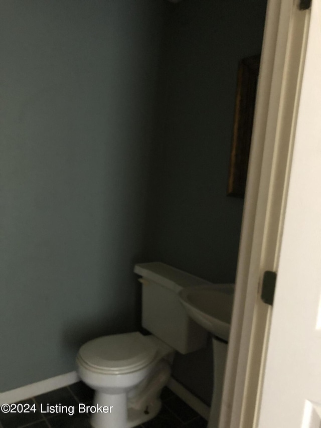 bathroom featuring tile patterned flooring and toilet