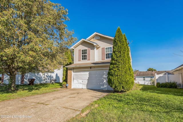 view of front of house featuring a front yard and a garage