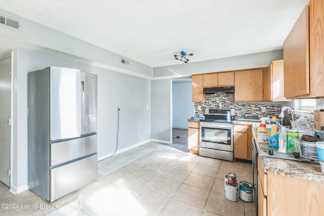 kitchen featuring a textured ceiling, light tile patterned flooring, stainless steel range with electric cooktop, and backsplash