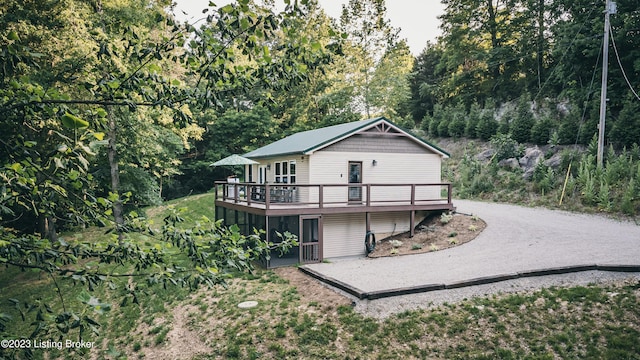 back of house featuring a wooden deck