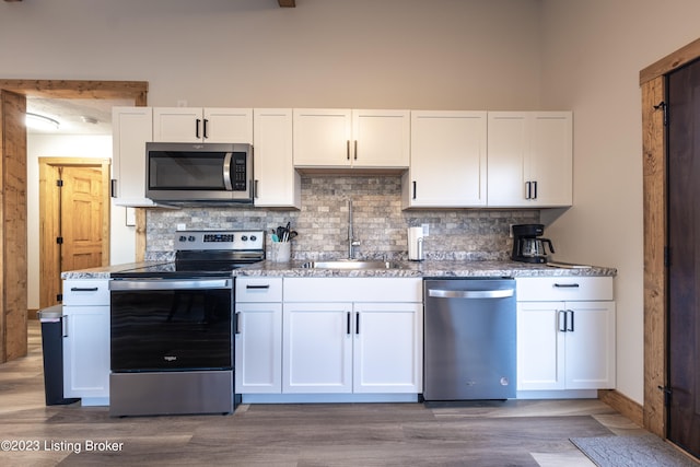 kitchen featuring white cabinetry, sink, and stainless steel appliances