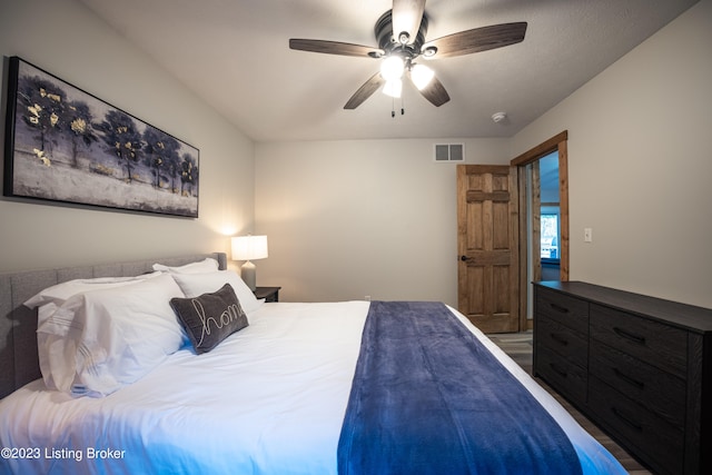 bedroom with ceiling fan and hardwood / wood-style flooring