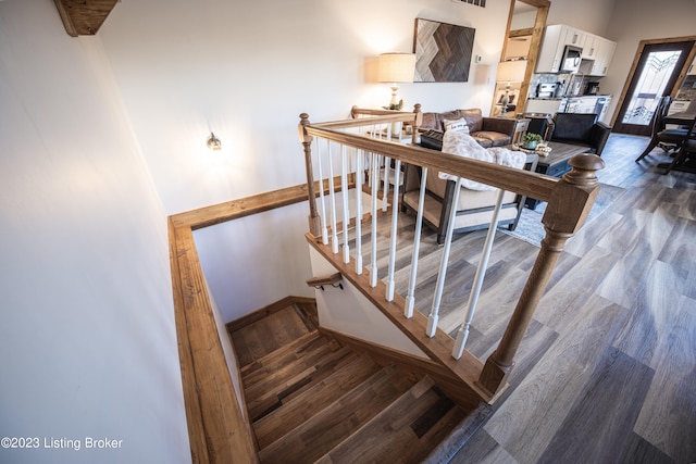 stairway featuring hardwood / wood-style flooring