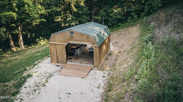 view of outbuilding featuring a lawn