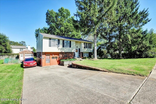 raised ranch with a garage and a front yard