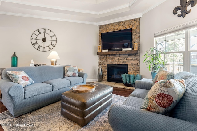 living room featuring hardwood / wood-style flooring, a fireplace, and ornamental molding