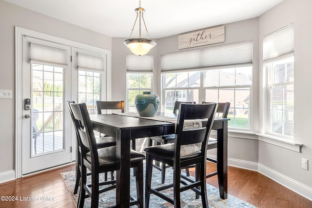 dining space with wood-type flooring