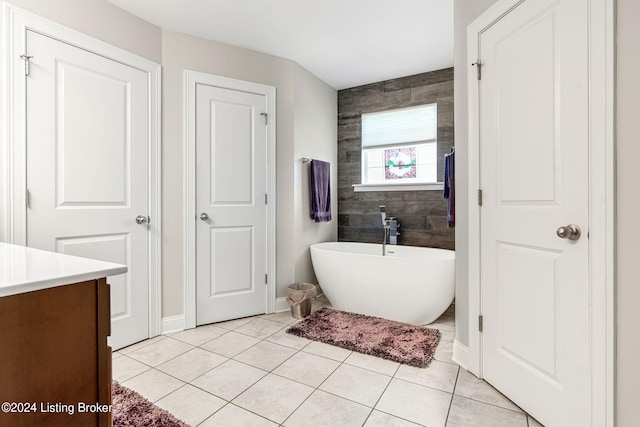 bathroom featuring a bathing tub, vanity, and tile patterned floors