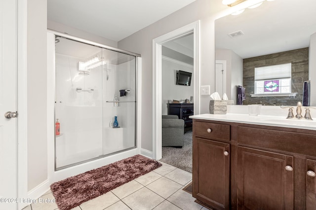 bathroom with walk in shower, vanity, and tile patterned flooring