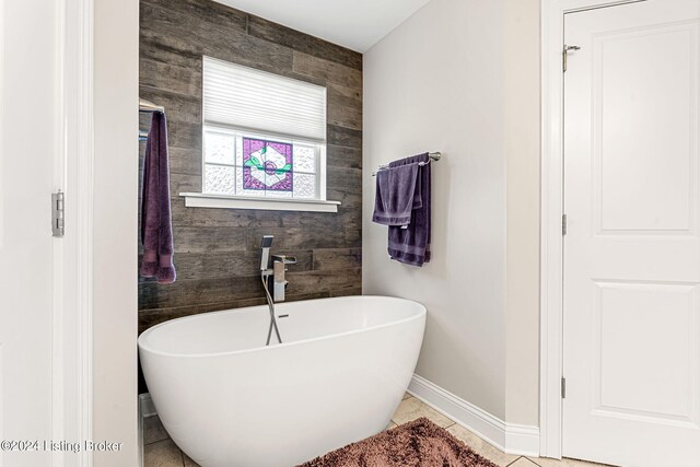 bathroom featuring a bath and tile patterned flooring