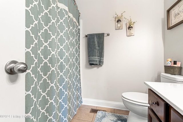 bathroom with curtained shower, vanity, toilet, and tile patterned floors