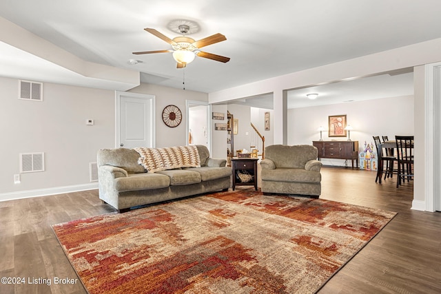 living room featuring wood-type flooring and ceiling fan