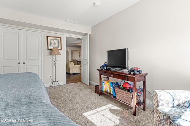 carpeted bedroom with a closet