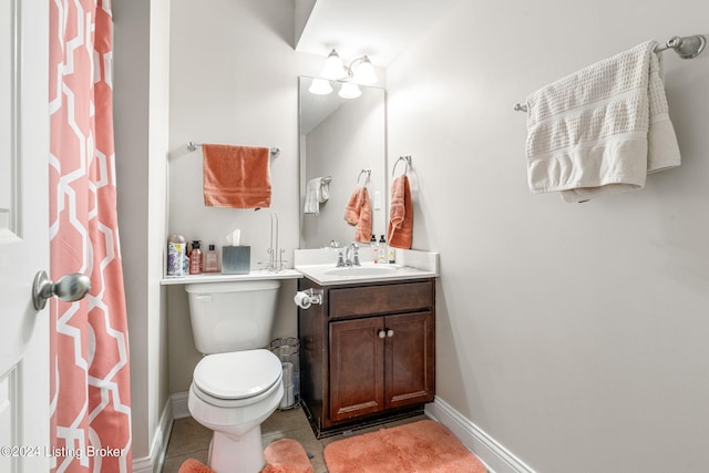 bathroom featuring tile patterned flooring, vanity, and toilet