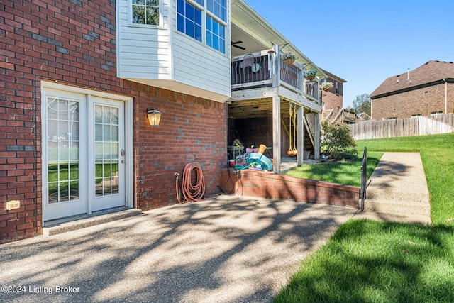 back of property with a yard and a wooden deck