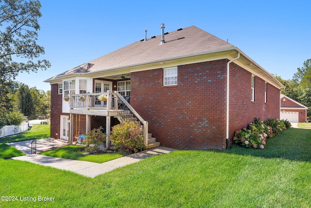 rear view of house featuring a garage and a yard