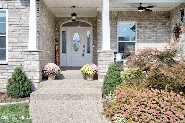 doorway to property featuring a porch and ceiling fan