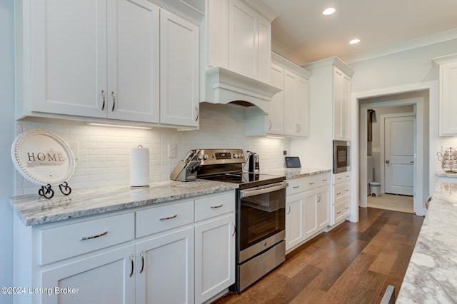 kitchen featuring white cabinets, decorative backsplash, and stainless steel appliances