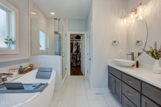 bathroom featuring vanity and a shower with door