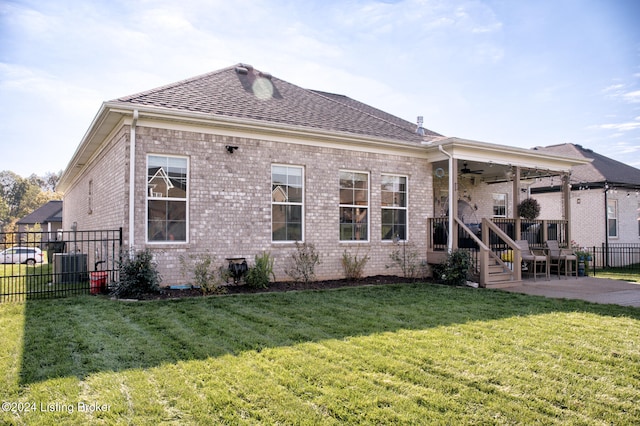 back of property featuring a patio, central AC, ceiling fan, and a lawn