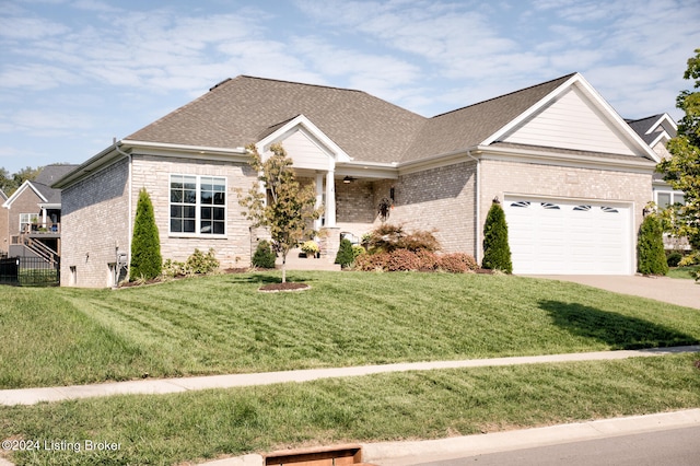 view of front of property with a garage and a front lawn