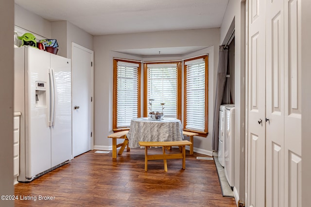 dining space featuring dark hardwood / wood-style floors and washing machine and dryer