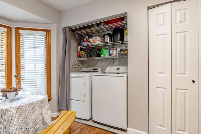 washroom with light hardwood / wood-style flooring and washer and clothes dryer