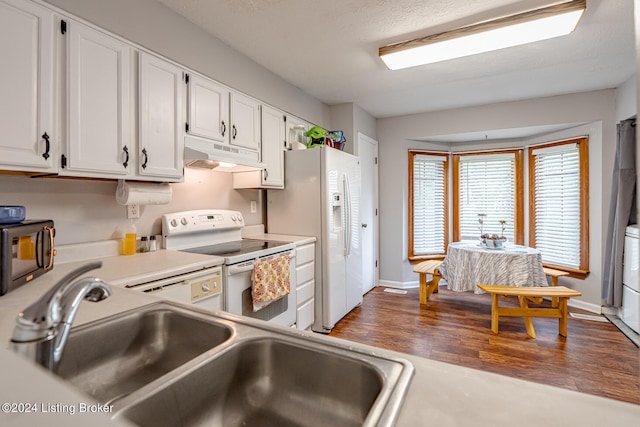 kitchen with white cabinets, sink, dark wood-type flooring, and white appliances