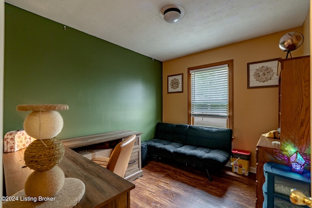 interior space with wood-type flooring and a textured ceiling