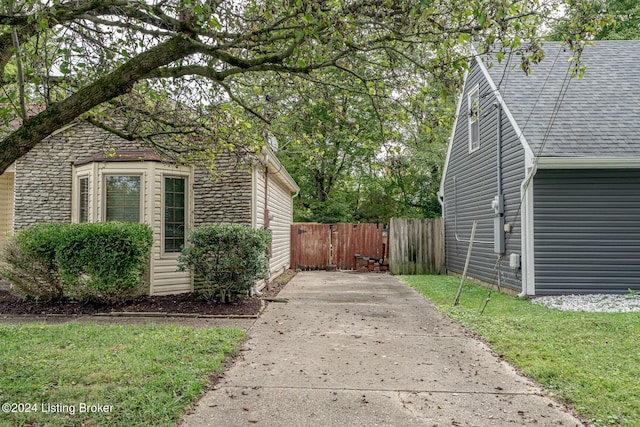 view of property exterior with a lawn