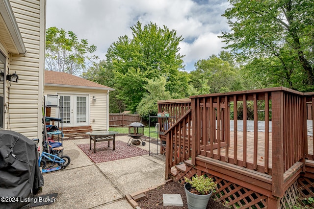 view of patio / terrace with a fire pit and a deck