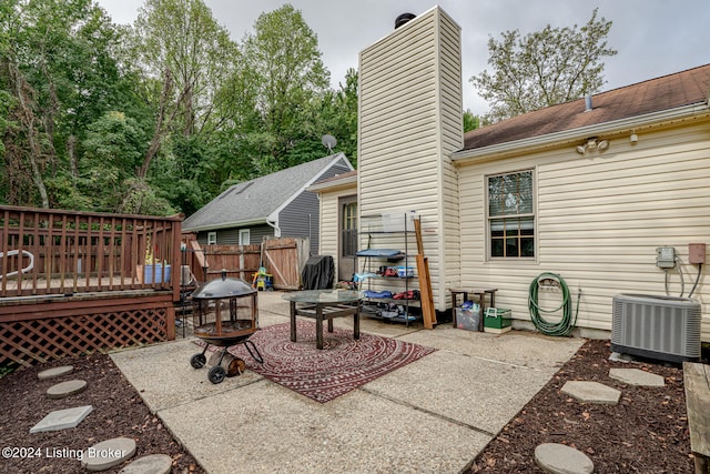 view of patio with cooling unit and a wooden deck