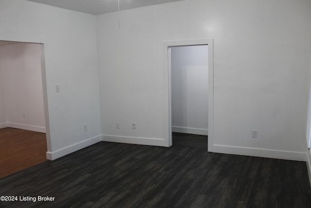 empty room featuring dark hardwood / wood-style flooring