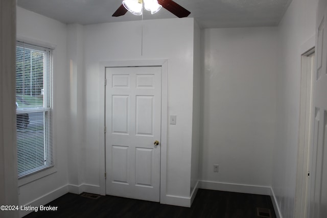 interior space featuring a closet, ceiling fan, and dark hardwood / wood-style flooring