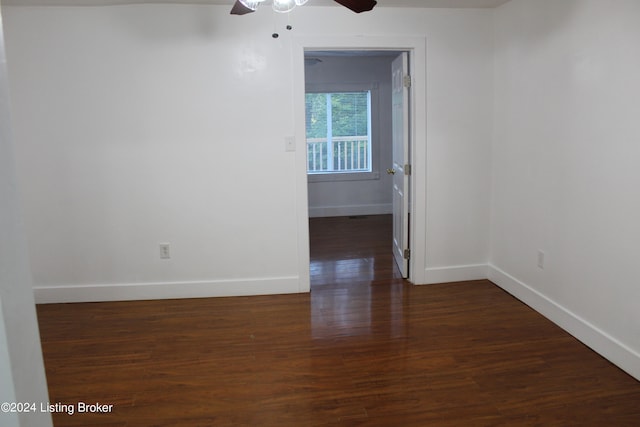 spare room featuring dark hardwood / wood-style flooring and ceiling fan