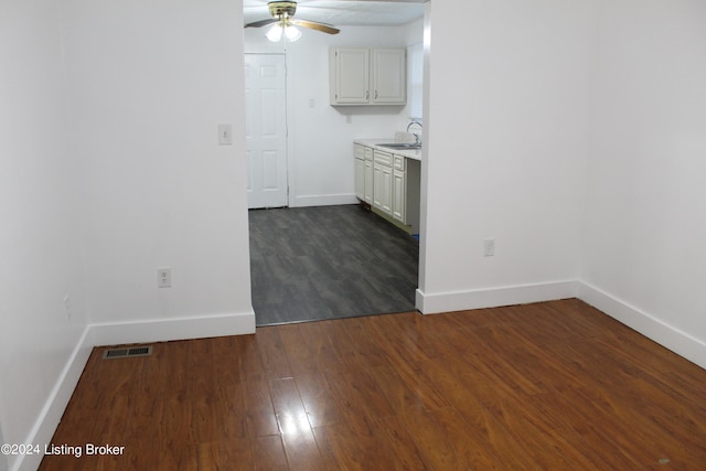 kitchen with white cabinets, ceiling fan, dark hardwood / wood-style floors, and sink