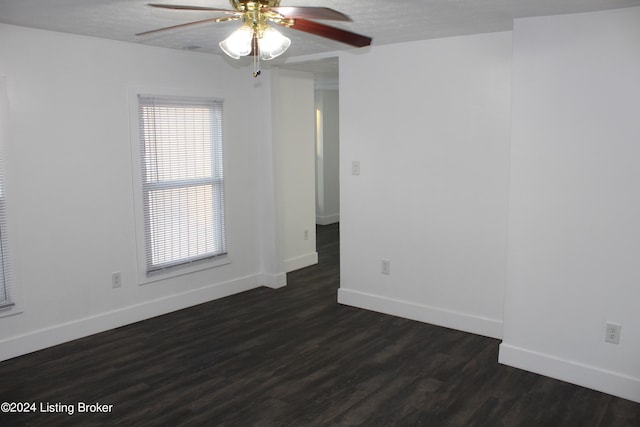 spare room featuring a textured ceiling, dark hardwood / wood-style floors, and ceiling fan