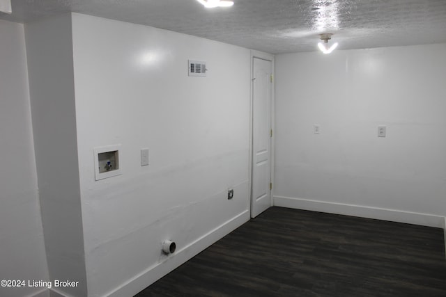 clothes washing area featuring a textured ceiling, dark hardwood / wood-style floors, and hookup for a washing machine