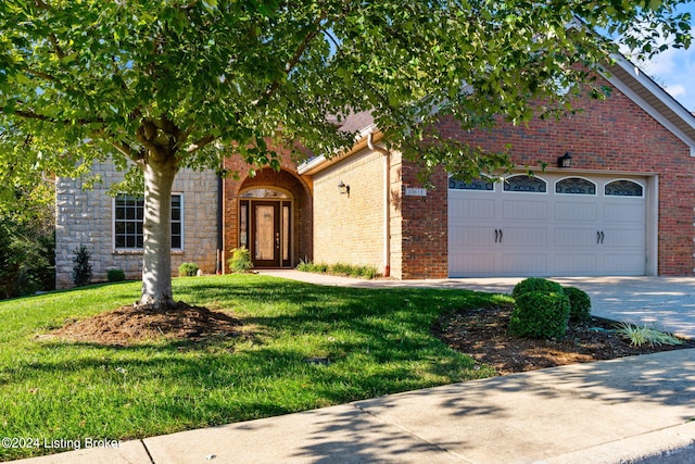 view of front facade with a front yard and a garage