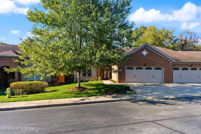 view of front of home featuring a front lawn and a garage