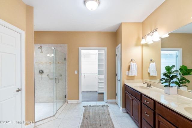 bathroom featuring tile patterned floors, vanity, and walk in shower