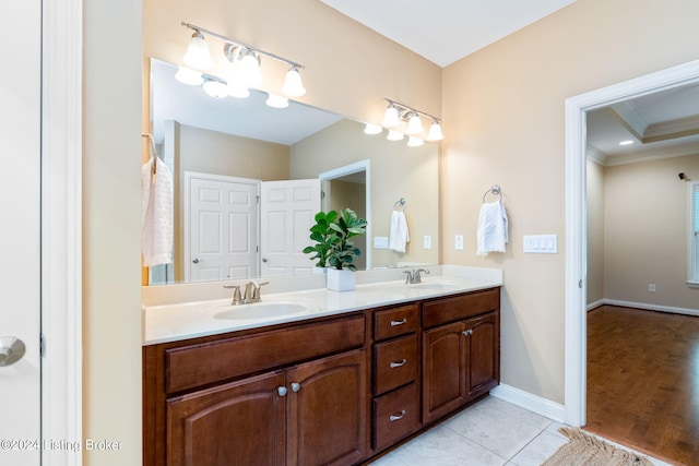 bathroom featuring crown molding, vanity, and hardwood / wood-style flooring