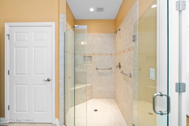 bathroom with a shower with shower door