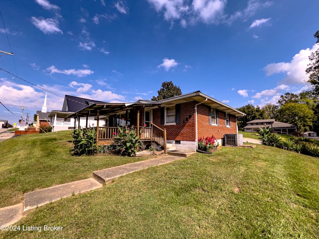 view of front of property with cooling unit and a front lawn