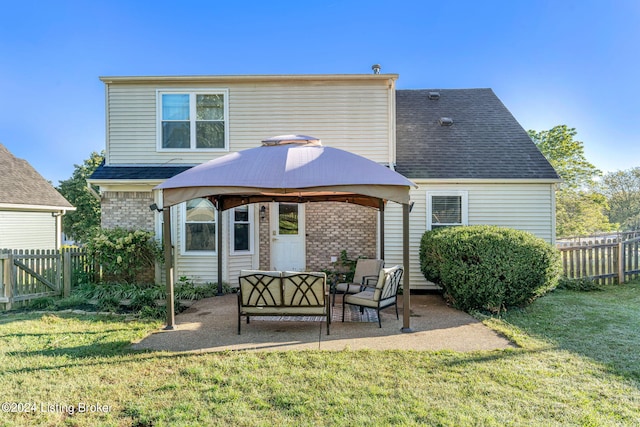 rear view of house featuring a lawn, a patio, an outdoor hangout area, and a gazebo