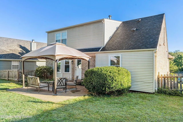 back of house with a gazebo, a lawn, and a patio area