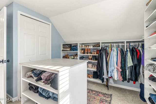 spacious closet featuring carpet floors and lofted ceiling